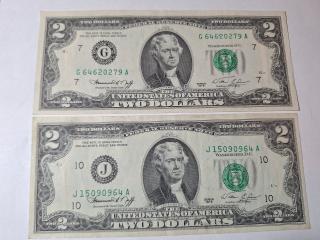 Two $2 bills, very good condition 