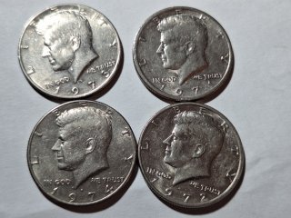 Four Kennedy half dollars 