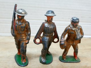 Three painted metal soldier figures, 4 in