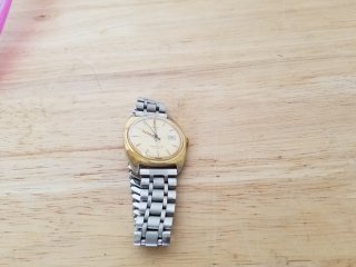 Silver and gold colored timex watch 