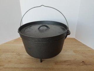 CAST iron cooker, footed, approx 15 by 9 inch