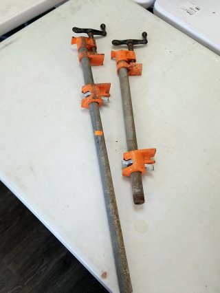 Two orange pipe clamps