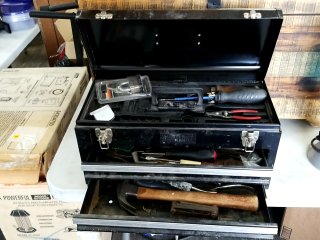 Black metal tool box with tools