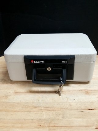 Item #9 — Sentry 1100 Fireproof Safe with keys, approx 14 by 10 by 7 inch