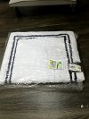 Item #17 — New White Bath Rug with Black Border 34 by 21 inch photo 1 of 2